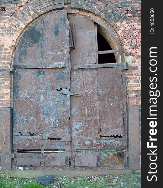 Rusted steel door on an old Brooklyn factory wall. Rusted steel door on an old Brooklyn factory wall.