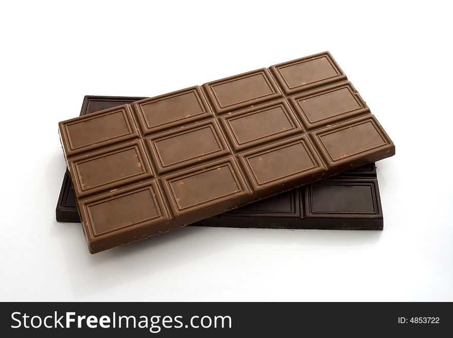 Blocks of black and milky chocolate isolated on white. Blocks of black and milky chocolate isolated on white