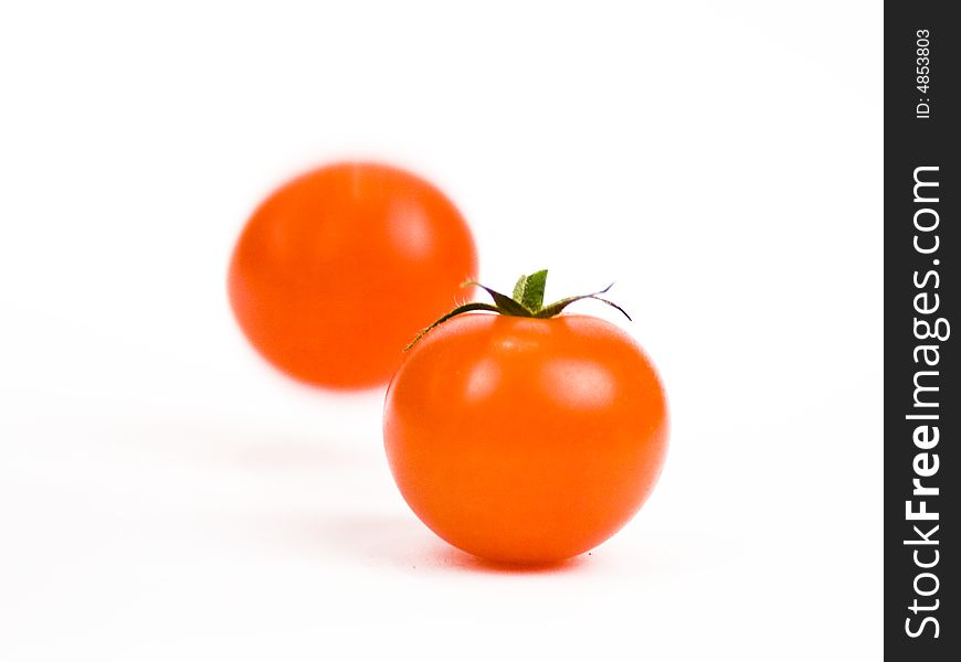 Tomato ingredient being dropped by hand. Tomato ingredient being dropped by hand