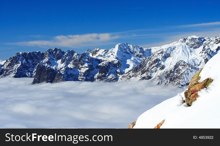 Mountains summits under a blue sky in winter. Mountains summits under a blue sky in winter