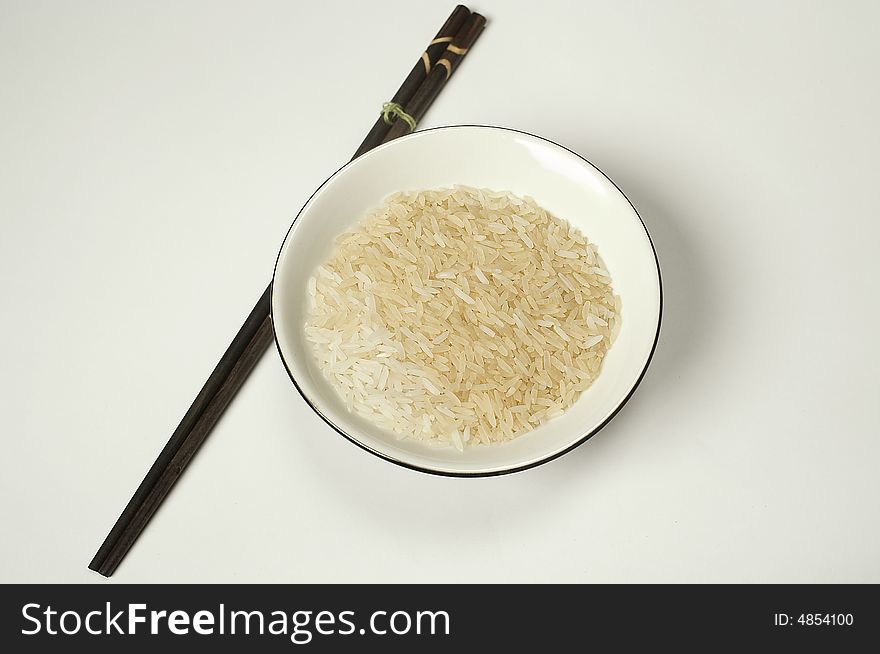 Bowl rice and japanese or chinese dark sticks. Bowl rice and japanese or chinese dark sticks