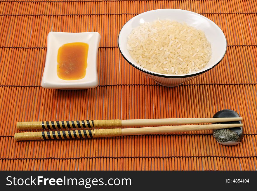 Place with rice bowl, japanese or chinese sticks, sauce and place-mat. Place with rice bowl, japanese or chinese sticks, sauce and place-mat