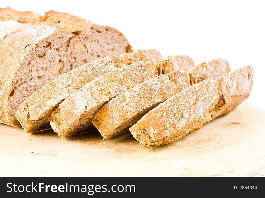 Sliced walnut bread on a wooden board