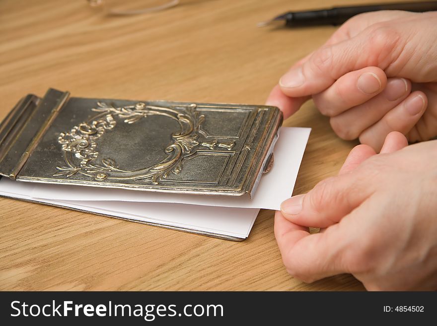 Drawing a paper from silver notebook cover for writing a note