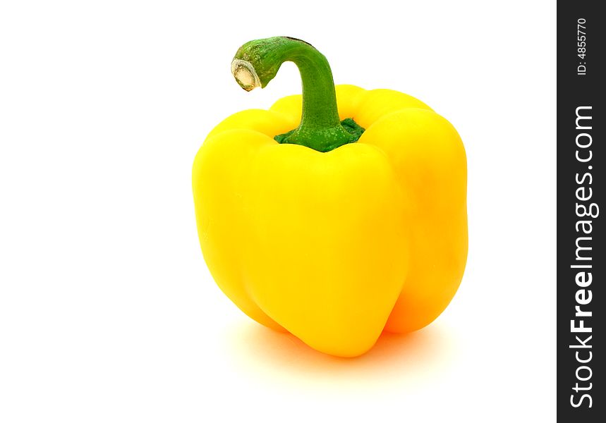 Fresh yellow pepper over a white surface