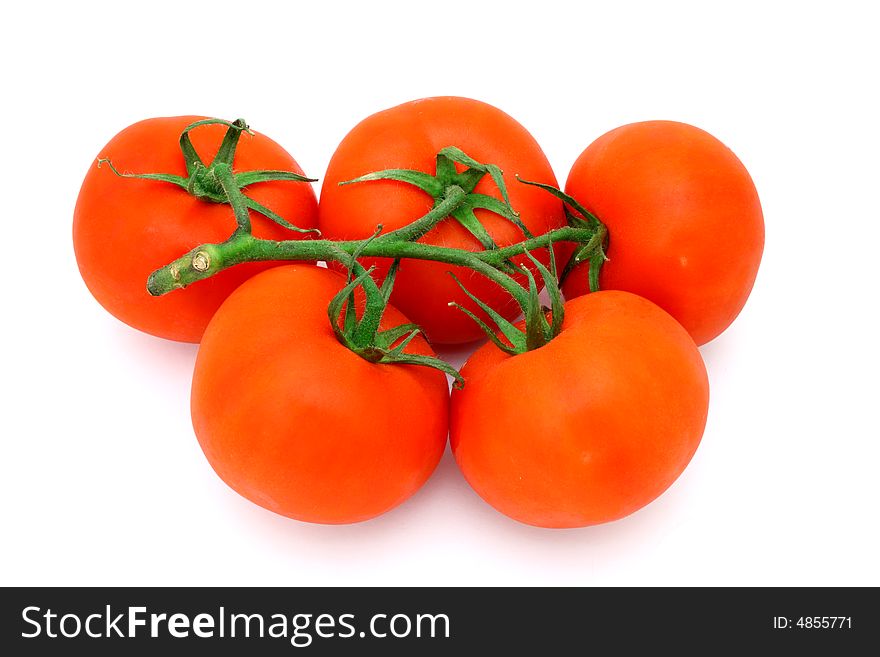 Five fresh and juicy tomatoes over a white surface