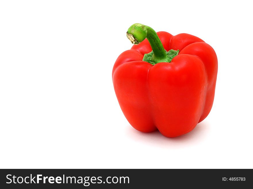 Fresh red pepper over a white surface