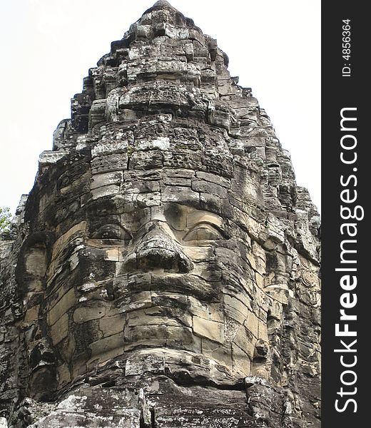 A Stone carving at the top of a temple as part of an Angkor Wat Temple. A Stone carving at the top of a temple as part of an Angkor Wat Temple