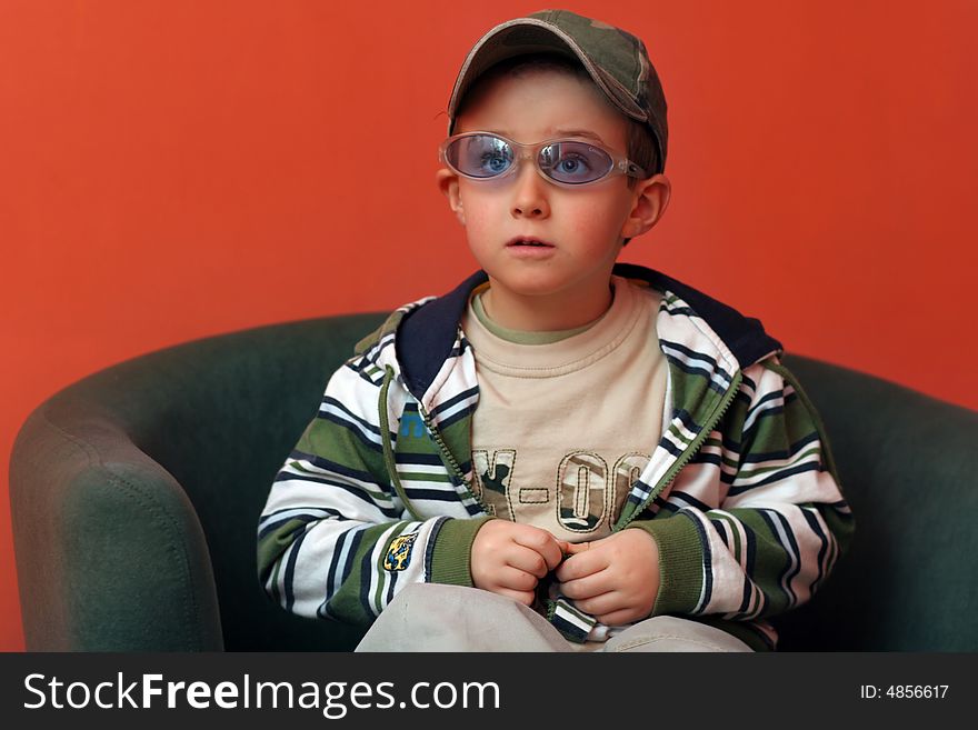 Boy Sitting On The Armchair