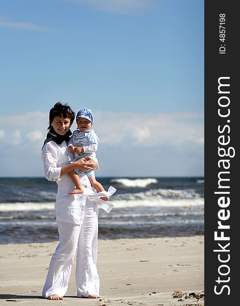 Mother  with her baby on the beach