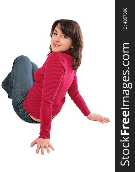 Young woman sits on floor on white