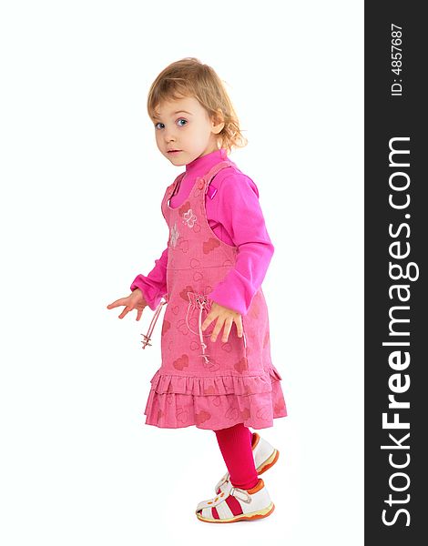 Little girl in pink dress on white