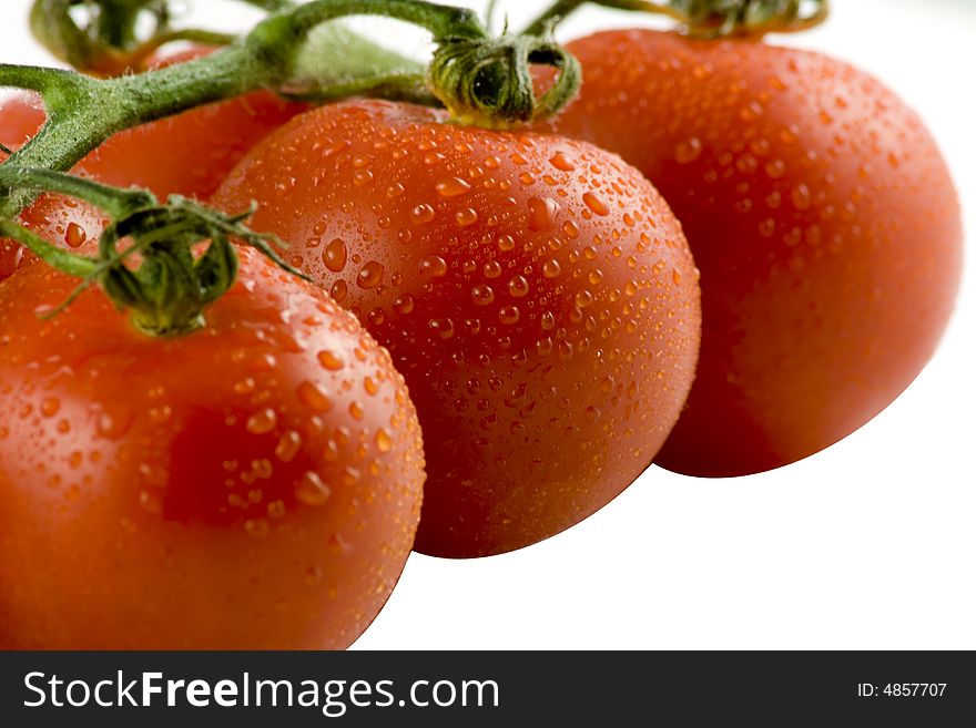 Red tomatos isolated on white, selective focus