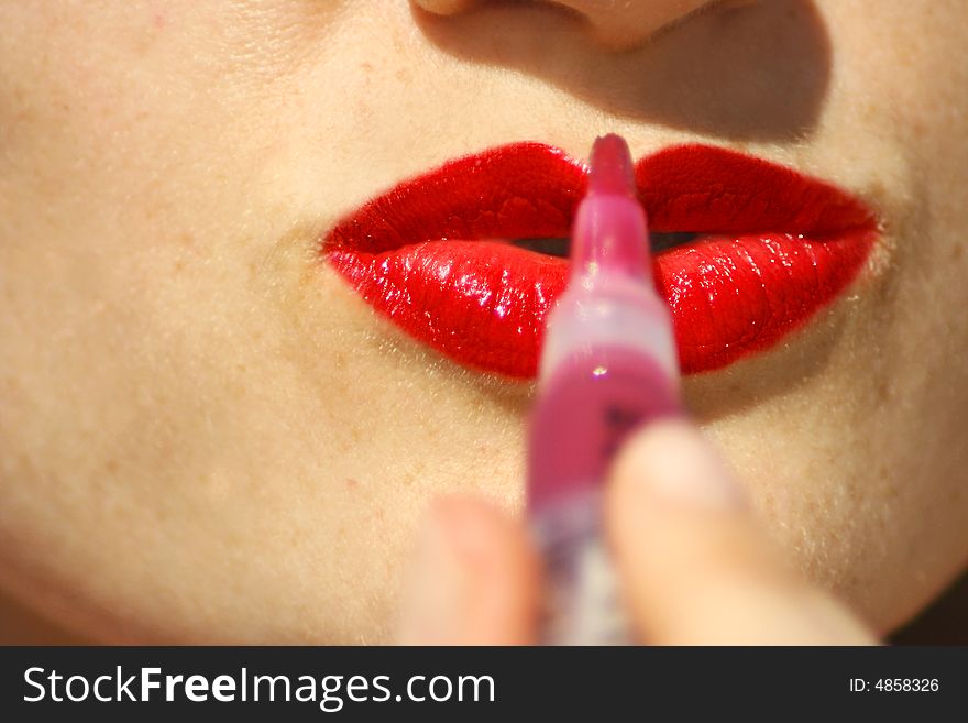 An image of a woman face making up. An image of a woman face making up