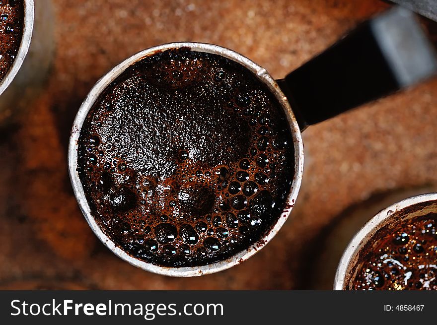 Cezve with hot turkish coffee on the hot sand. Cezve with hot turkish coffee on the hot sand.