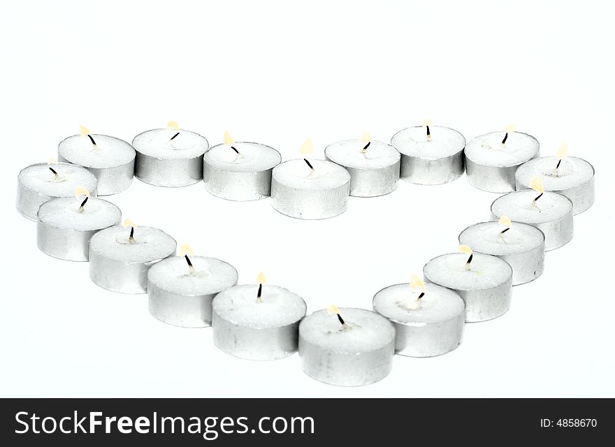 Heart from candles on a white background