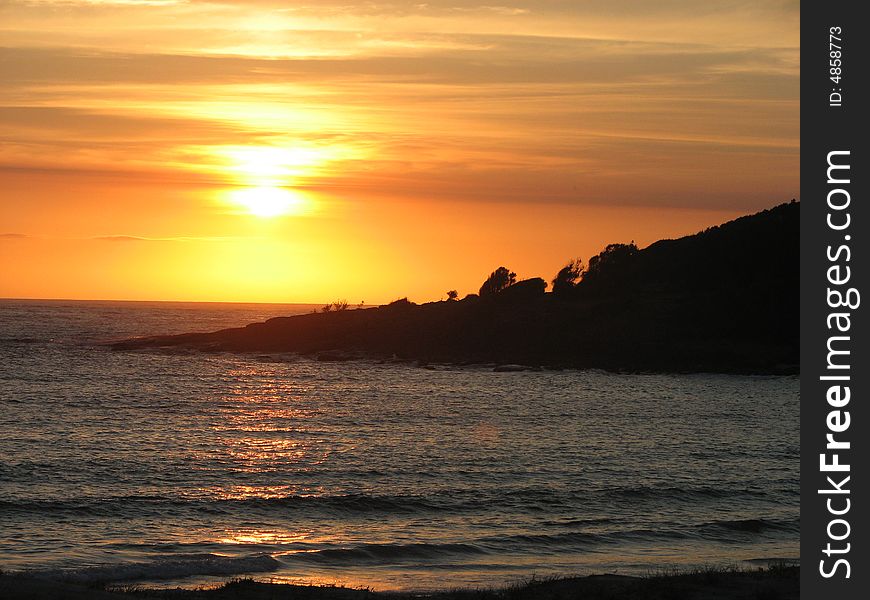 Sunrise at Kioloa Beach over a silhouette headland. Sunrise at Kioloa Beach over a silhouette headland.