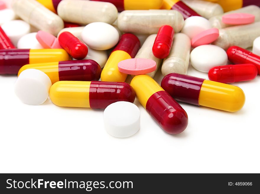 Assorted pills and capsules on white background. Assorted pills and capsules on white background