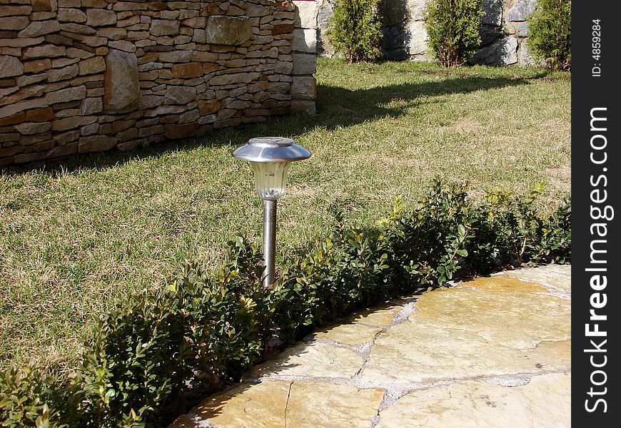 Garden stone path with grass growing up between the stones