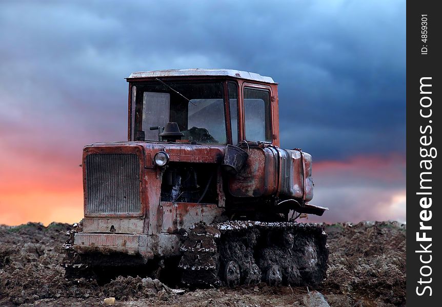 Old caterpillar tractor stands on lifeless terrain. Old caterpillar tractor stands on lifeless terrain