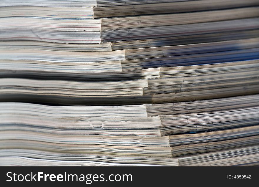 Stack of magazines at the bookshelf