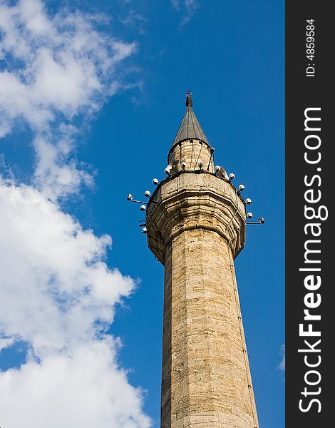 Single mosque minaret under the blue sky