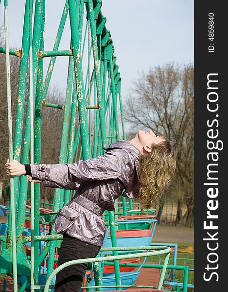 Girl in park on  old swing. Breathes fresh spring air. Girl in park on  old swing. Breathes fresh spring air.