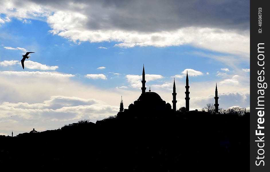 Istanbul Suleymaniye mosque silhouette, light play of sun and cloud shadow skyline.Kanuni Sultan SÃ¼leyman mosque. Istanbul Suleymaniye mosque silhouette, light play of sun and cloud shadow skyline.Kanuni Sultan SÃ¼leyman mosque.