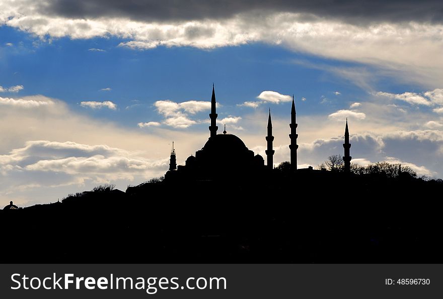 Istanbul Suleymaniye mosque silhouette, light play of sun and cloud shadow skyline.Kanuni Sultan SÃ¼leyman mosque. Istanbul Suleymaniye mosque silhouette, light play of sun and cloud shadow skyline.Kanuni Sultan SÃ¼leyman mosque.