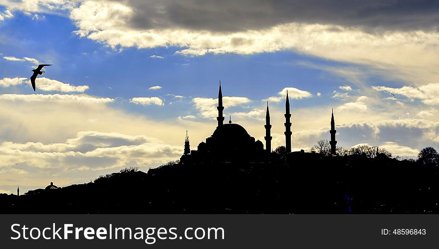 Istanbul Suleymaniye mosque silhouette, light play of sun and cloud shadow skyline.Kanuni Sultan SÃ¼leyman mosque. Istanbul Suleymaniye mosque silhouette, light play of sun and cloud shadow skyline.Kanuni Sultan SÃ¼leyman mosque.