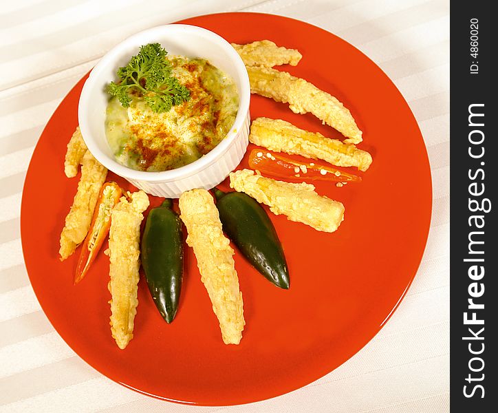 Avocado dip with deep fried chili peppers. Avocado dip with deep fried chili peppers