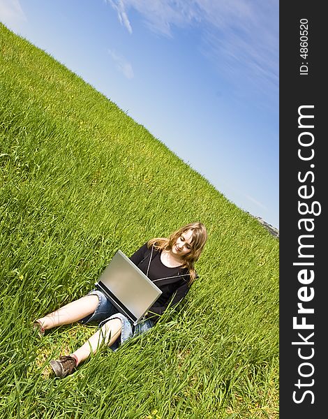 Blonde woman connected to the internet in a meadow. Blonde woman connected to the internet in a meadow