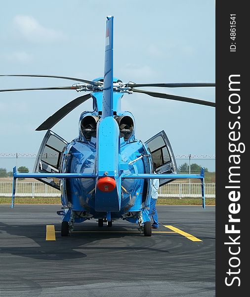 Rear view of twin engine, blue passenger helicopter at an airport. Rear view of twin engine, blue passenger helicopter at an airport.