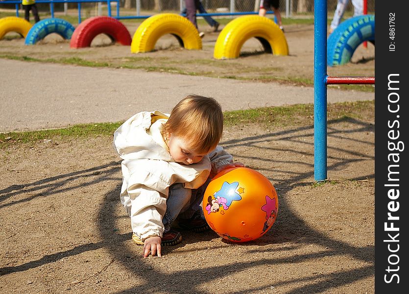 Small girl plays on the stadium