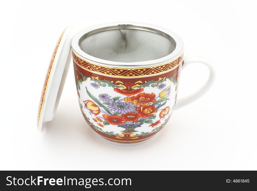 Tea cup with strainer on white background.