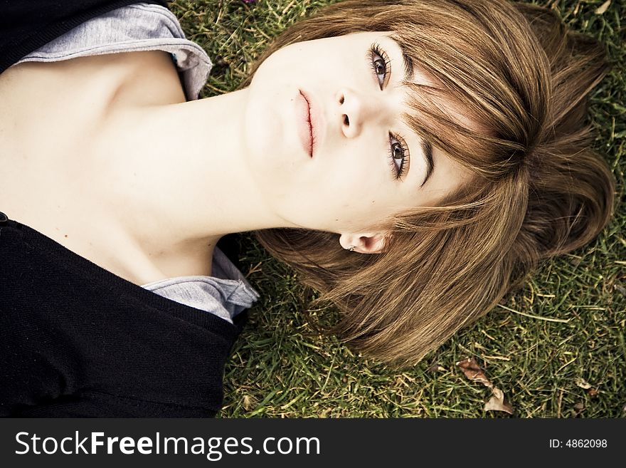 Beautiful lying woman in green grass