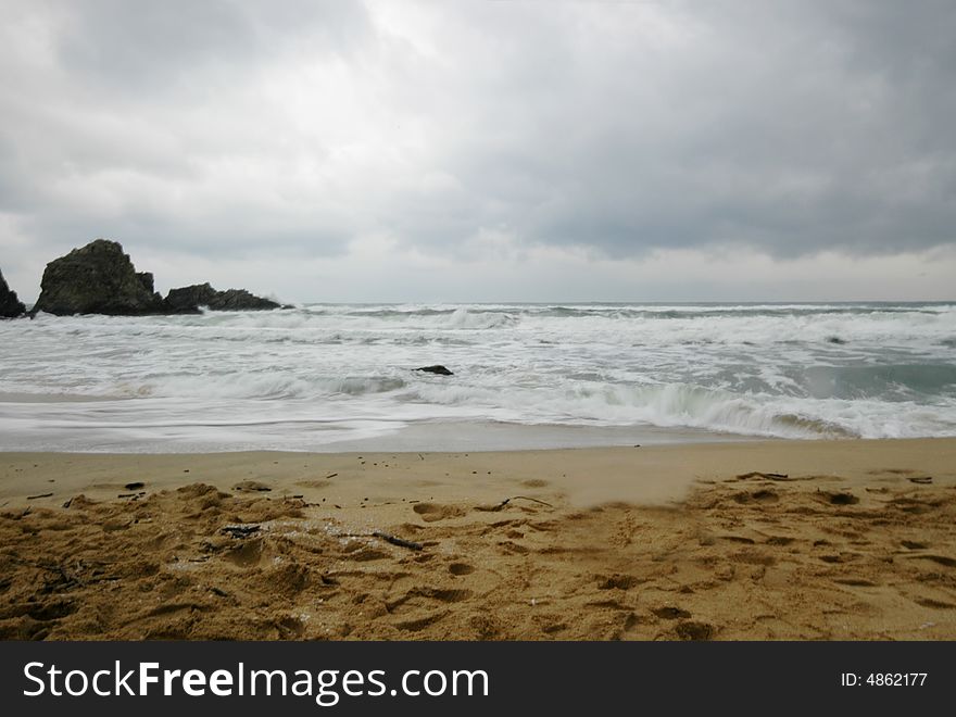 A sandy beach on a scenic, cloudy afternoon. A sandy beach on a scenic, cloudy afternoon.