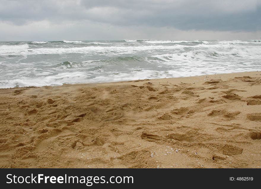 A sandy beach on a scenic, cloudy afternoon. A sandy beach on a scenic, cloudy afternoon.