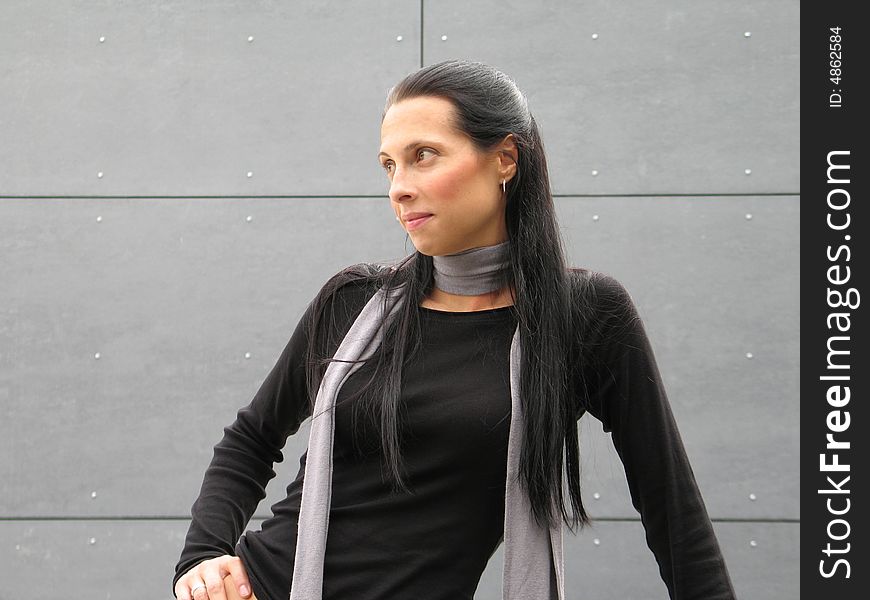 Long black hair woman against grey wall