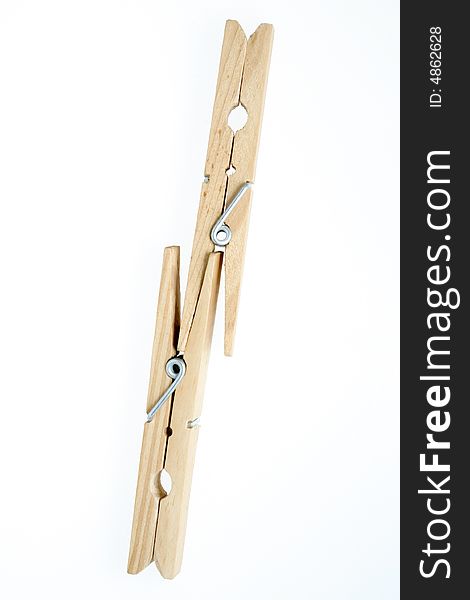 Two isolated wooden clothespins, pegs. Two isolated wooden clothespins, pegs