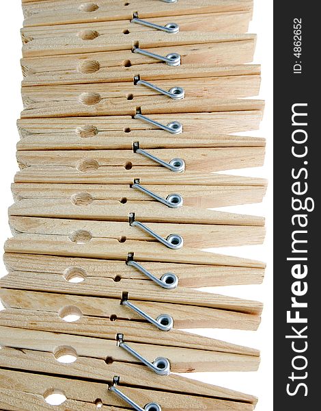Twelve isolated wooden clothespins in a row. Twelve isolated wooden clothespins in a row