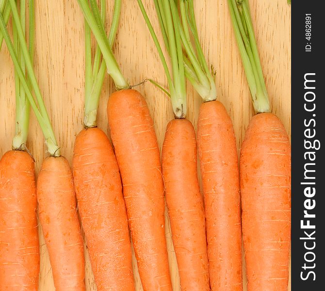 Close up of carrots on a wooden board. Close up of carrots on a wooden board