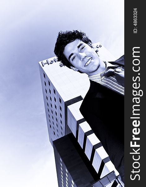 Young businessman portrait against urban background