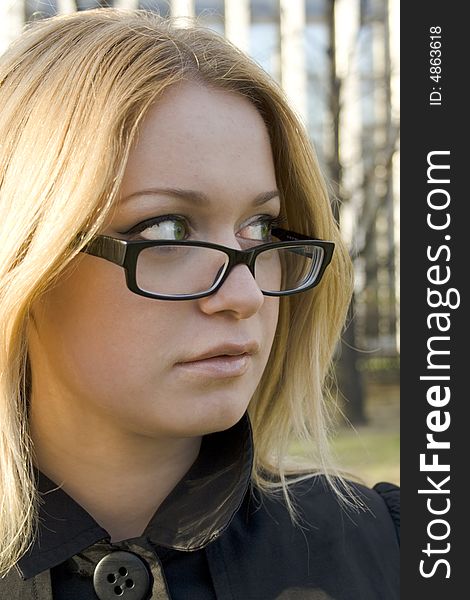 Attractive businesswoman in glasses outdoors