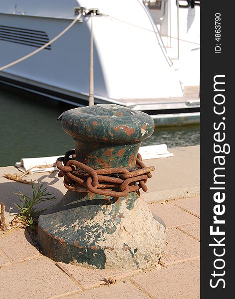 Rusty chain on pristane and rope from yacht