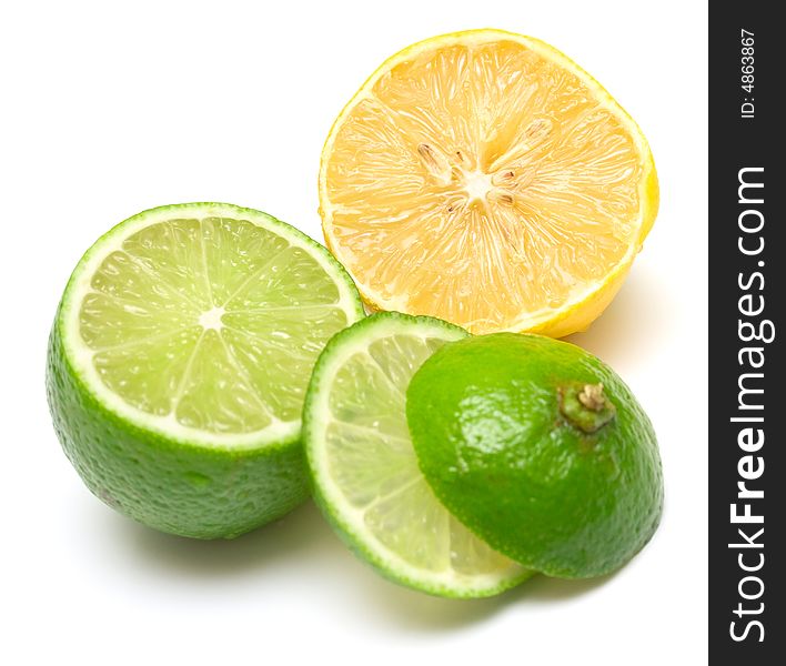 Lemon and lime on white. Segments of two citrus are mixed among themselves. Isolation, shallow DOF.