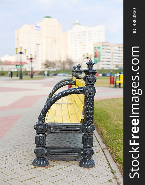 Park Bench With City Skyline Behind