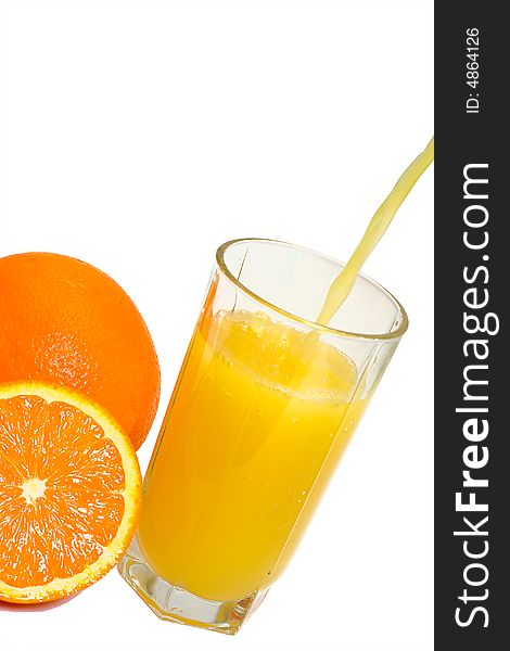 Oranges and glass filling with juice, isolated on white