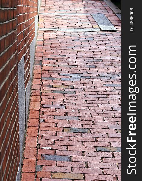 Brick wall with brick sidewalk, early america. Brick wall with brick sidewalk, early america