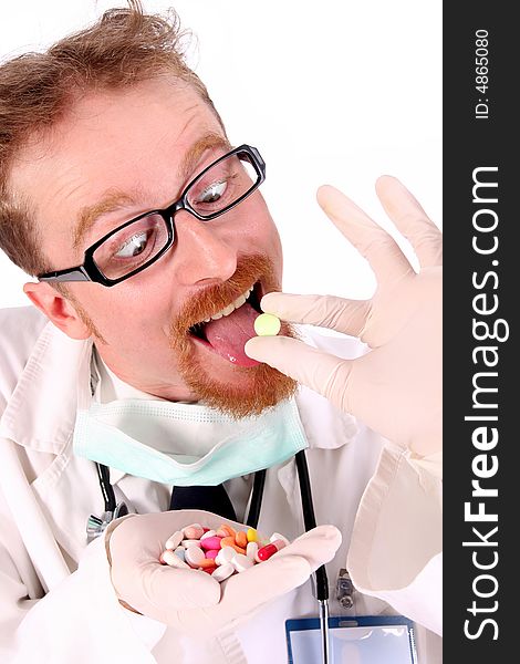 Doctor taking hand full of tablets on white background